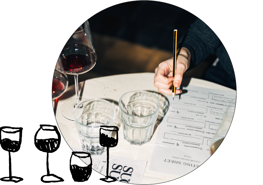 suc-suc-cata-vino-barcelona Person’s hand writing notes at natural wine tasting