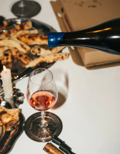 Juicy red natural wine paired with pizza.